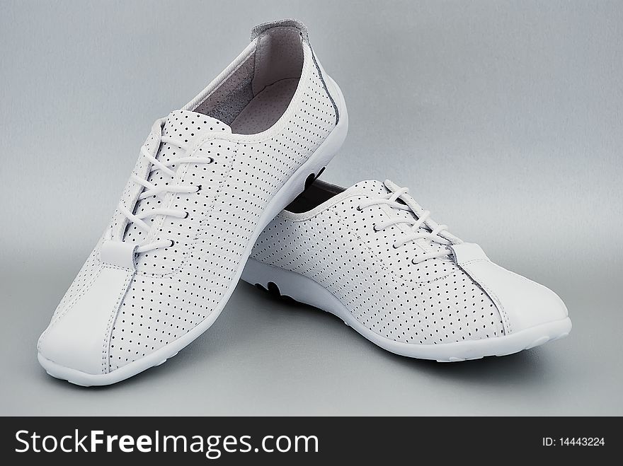 White athletic women's shoes with laces