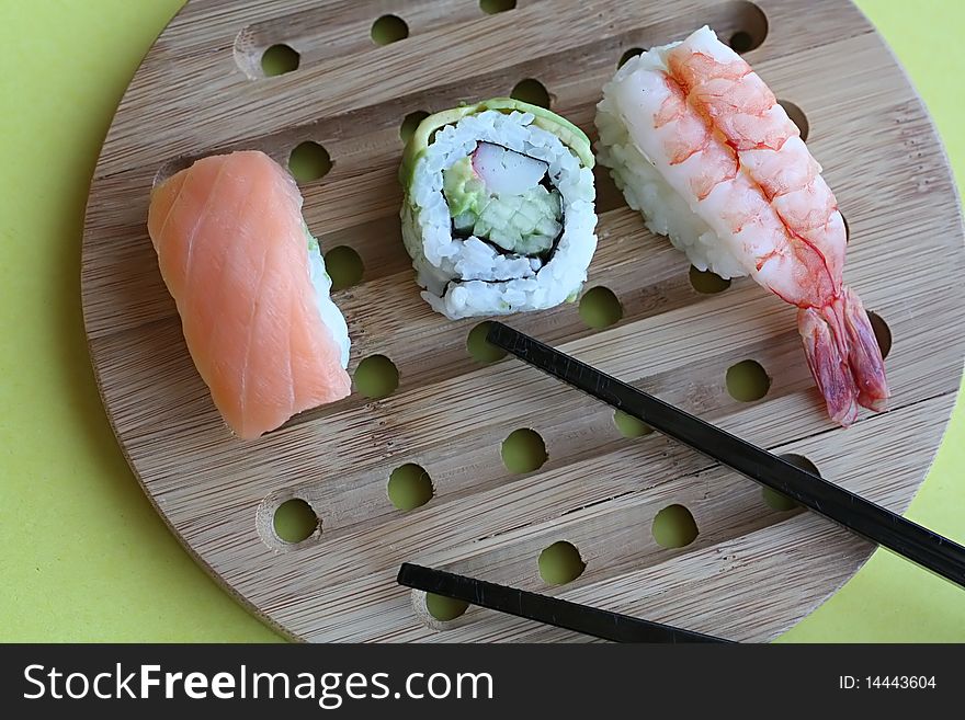 Sushi rolls on wooden plate. Sushi rolls on wooden plate