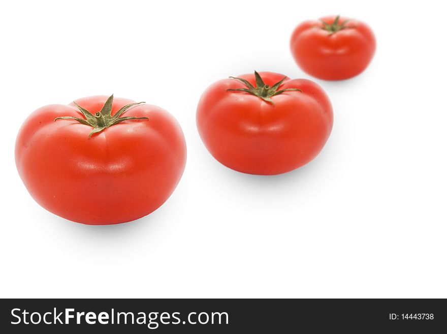 Red and fresh tomatoes on a white background. Red and fresh tomatoes on a white background