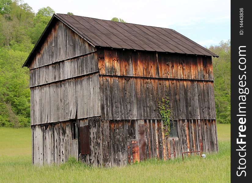 Old weathered wood barn with rusted metal roof. Old weathered wood barn with rusted metal roof