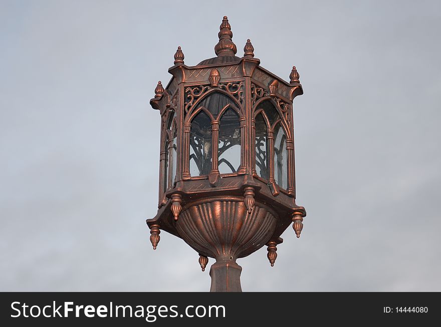A bronze medieval lamppost made of bronze.