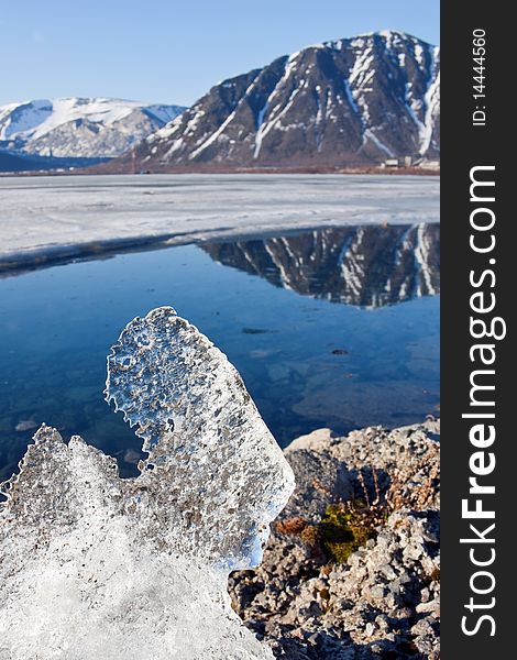 Big piece of ice on coast of lake in mountains. Big piece of ice on coast of lake in mountains