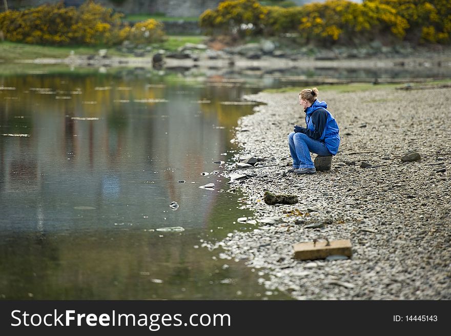 Woman by Loch with copy space.