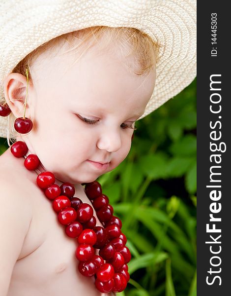 Girl and cherries in green leaves background