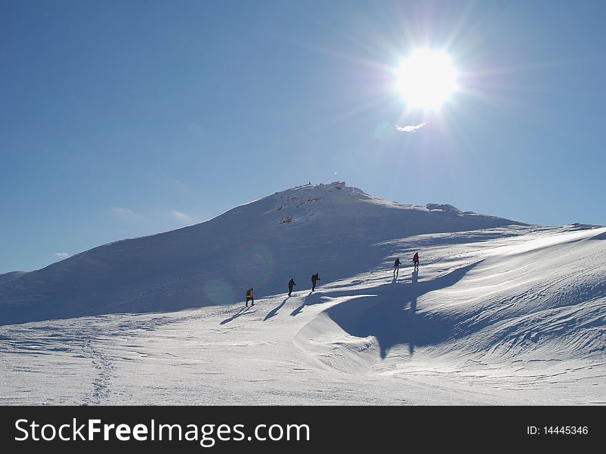 Winter mountain landscape with tourists.