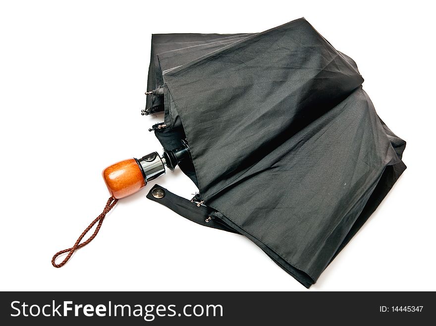 Closed black umbrella isolated on white background