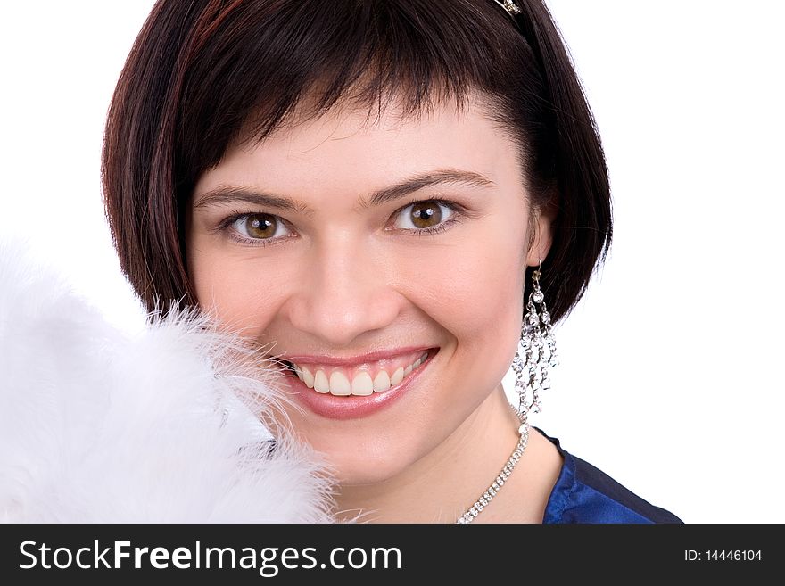 Close-up of beautiful woman with white feather. The angel has perfect eyes and white feathers. Beautiful model with snowy wintry look on white background.