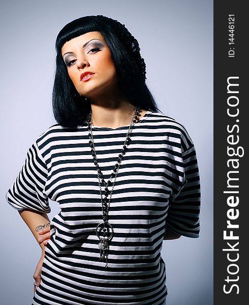 Attractive fashion woman posing in a striped top