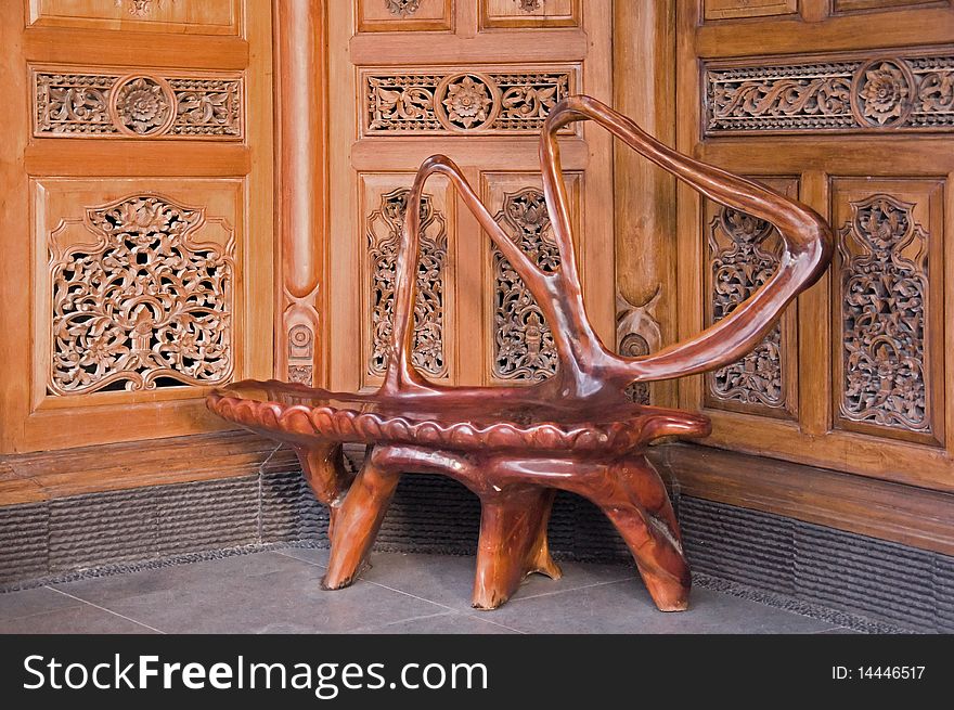 Beautiful outdoor tree root chair, with Balinese wooden door.