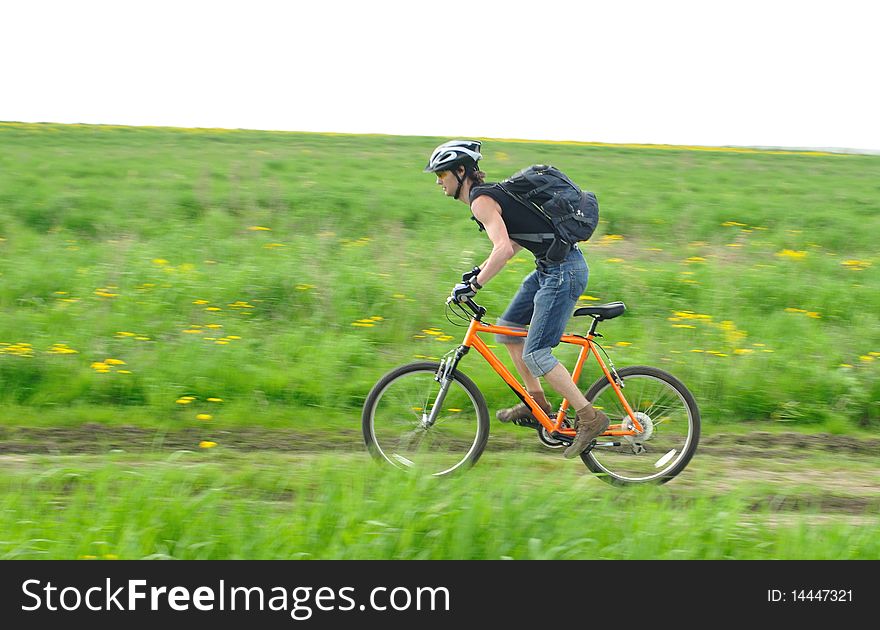 Cyclist during his training; cyclist is relatively in focus and background is slightly blurred by camera motion. Cyclist during his training; cyclist is relatively in focus and background is slightly blurred by camera motion