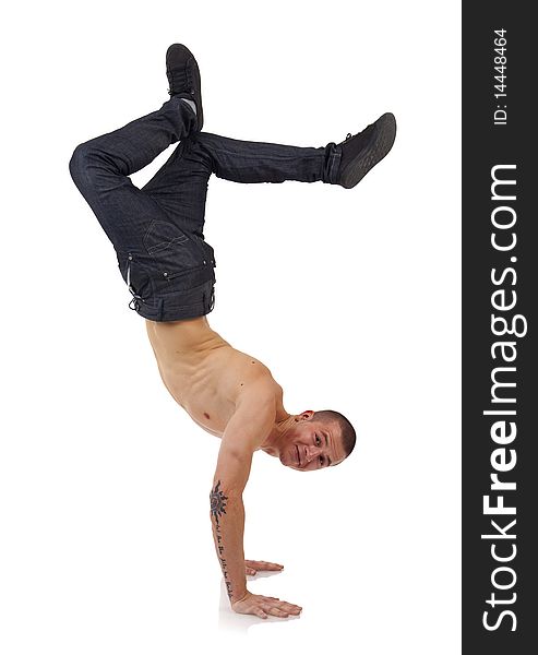 Young bboy standing on hands. Holding legs in air. Smiling and looking at camera. Isolated on white in studio. Young bboy standing on hands. Holding legs in air. Smiling and looking at camera. Isolated on white in studio.