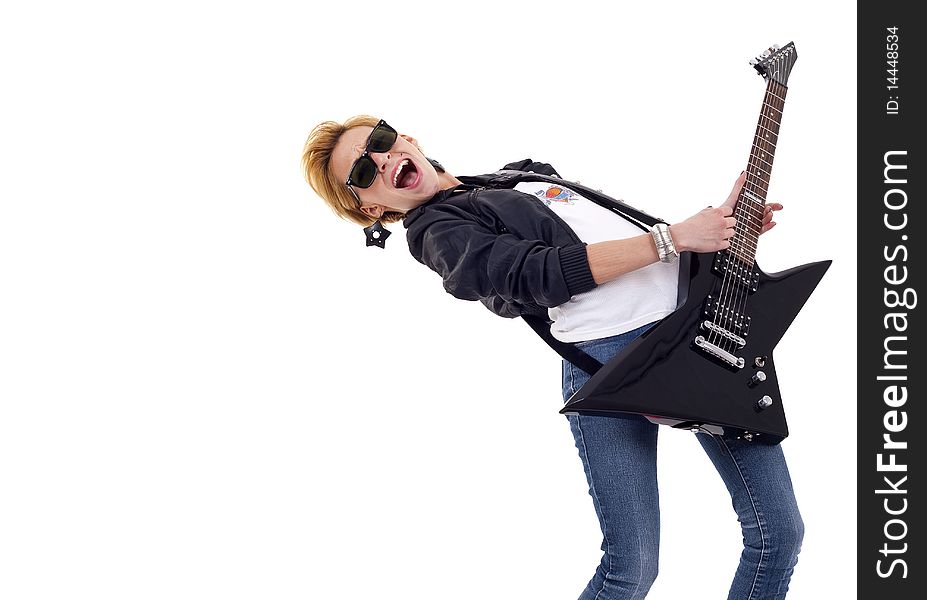 Beautiful young and attractive woman playing an electric guitar - with lots of copyspace. Beautiful young and attractive woman playing an electric guitar - with lots of copyspace