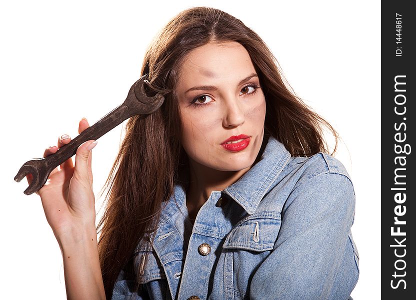 Young beautiful woman in jeans jacket with wrench. Young beautiful woman in jeans jacket with wrench