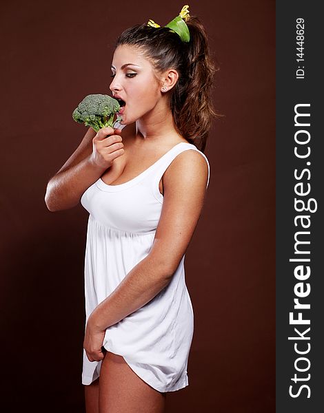 Beautiful young woman with fresh raw broccoli. Beautiful young woman with fresh raw broccoli