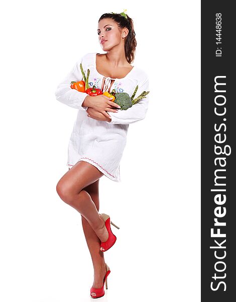 Young beautiful woman with fresh vegetables in her hands. Young beautiful woman with fresh vegetables in her hands