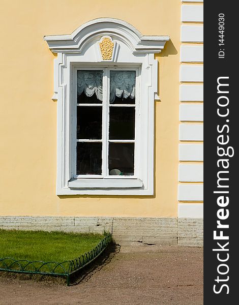 Old white window on yellow wall