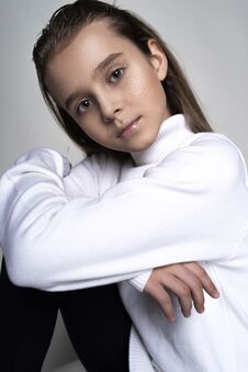 Portrait Of A Cute Teen Girl Wearing A White Turtleneck Sweater. Isolated On Gray Background. Advertising, Trendy And Commercial Royalty Free Stock Photos