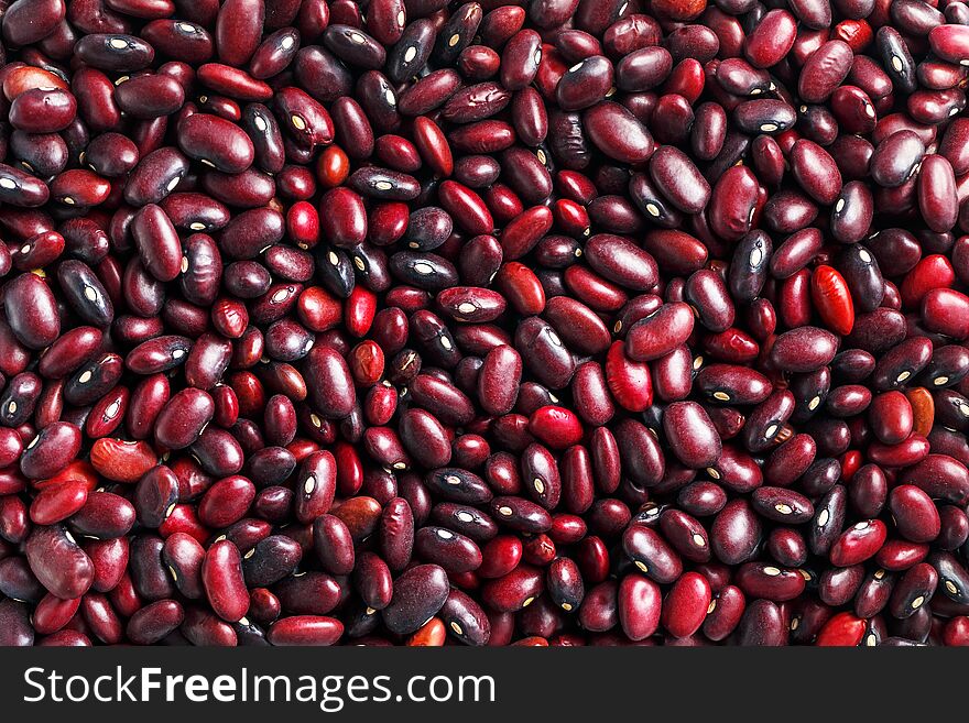 Closeup of a grain of red bean seeds. The texture of the legumes. Close up red beans background, seeds of red beans. Bean useful superfood