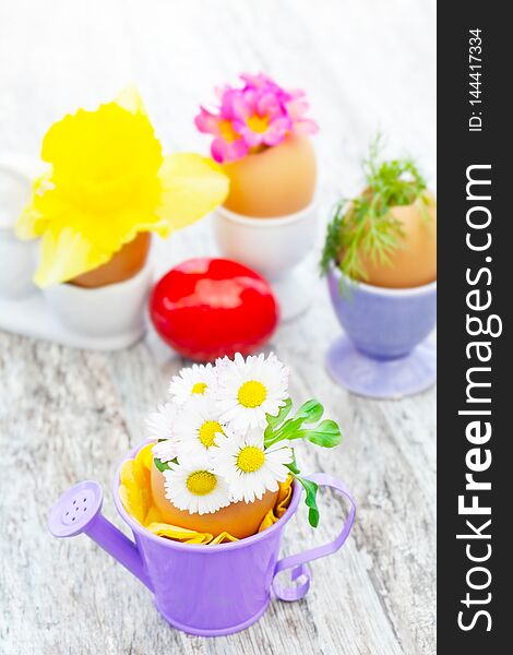 Easter decoration on table with daisies and other flowers. Easter decoration on table with daisies and other flowers