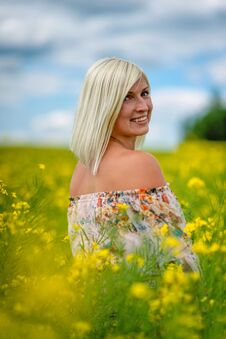 Soft, Selective Focus. Beautiful, Attractive, Blond Woman In A Yellow Flower Meadow Royalty Free Stock Image