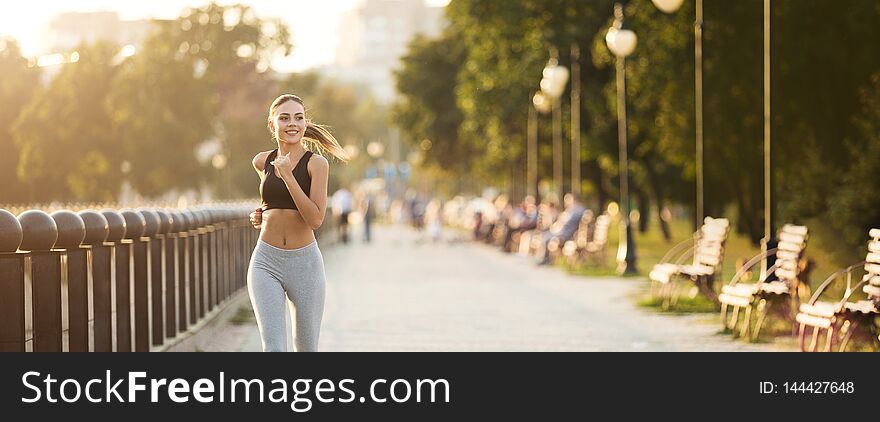 Millennial fitness woman jogging outdoors in park