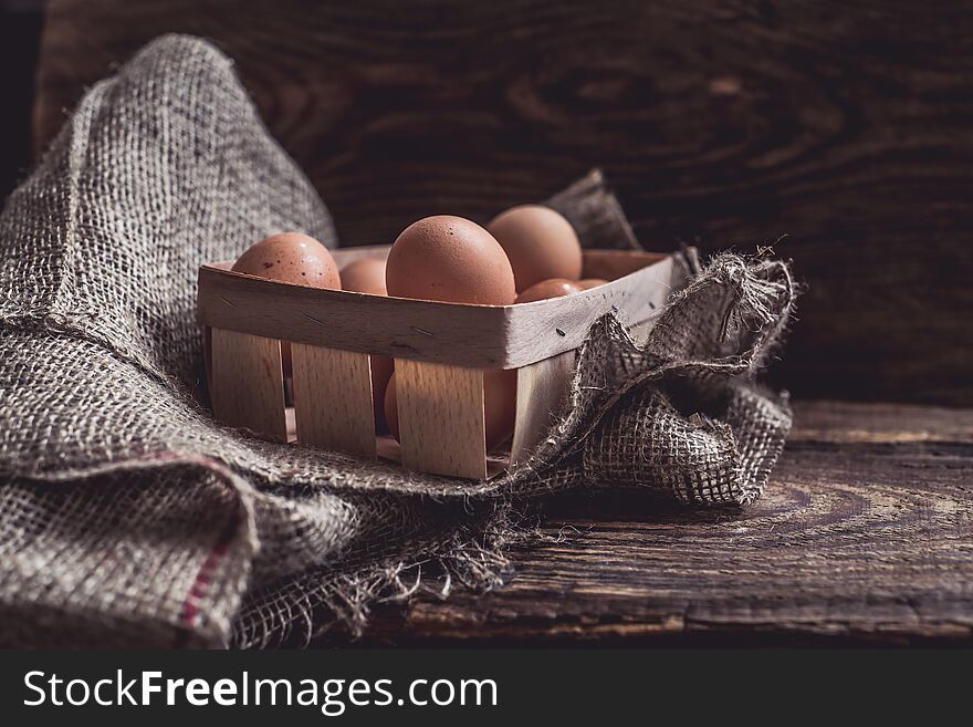 A pottle of farm eggs on rural wooden background. A pottle of farm eggs on rural wooden background