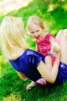 Girl Sits On Her Mother S Knees On A Green Lawn Stock Image Girl Sits On Her Mother S Knees On A Green Lawn Stock Image