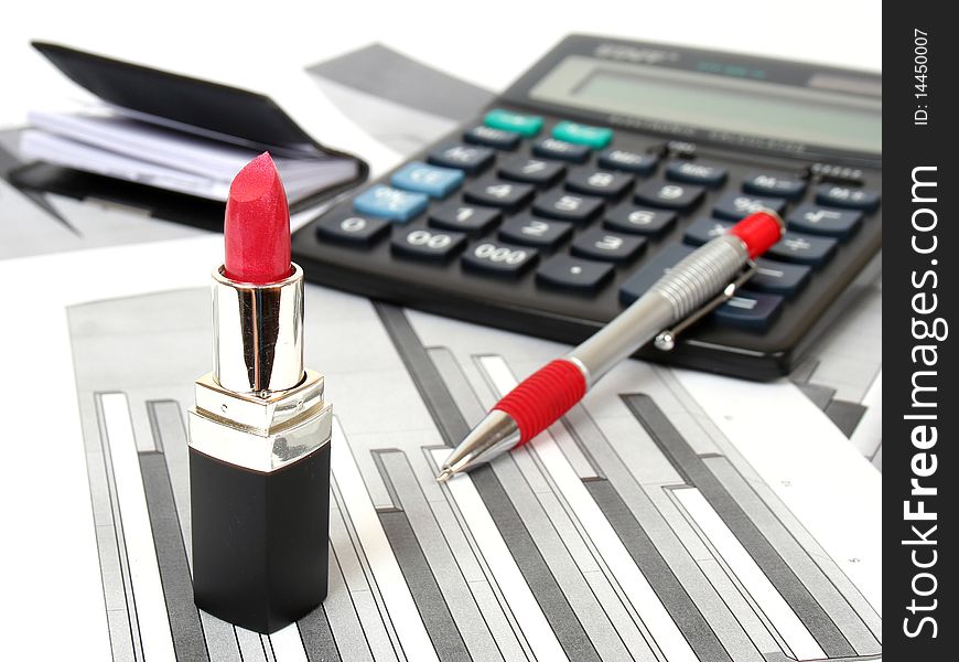 The calculator, the handle and female lipstick. The calculator, the handle and female lipstick