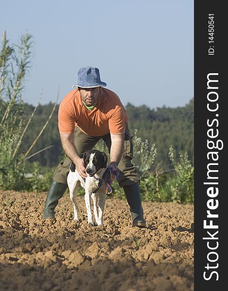 Farmer walking with is dog on the farm