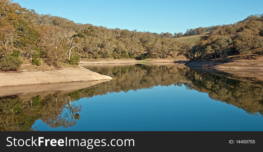 This is an early morning shot of a lake showing surface reflection. This is an early morning shot of a lake showing surface reflection.