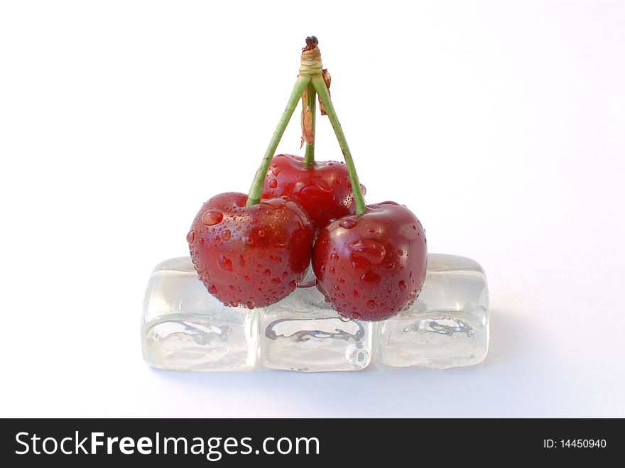 Three cherries with ice white background