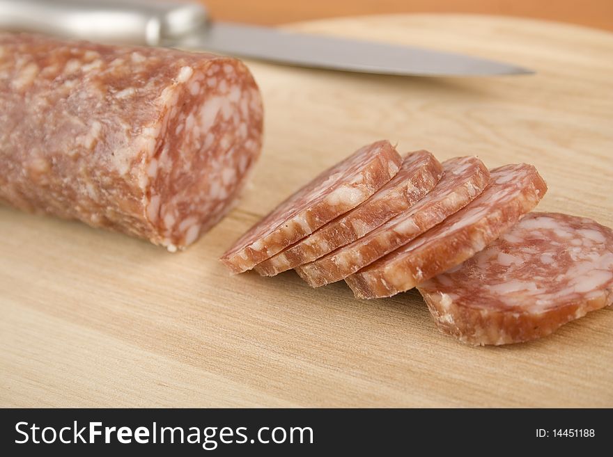 Sausage cut into a wooden board