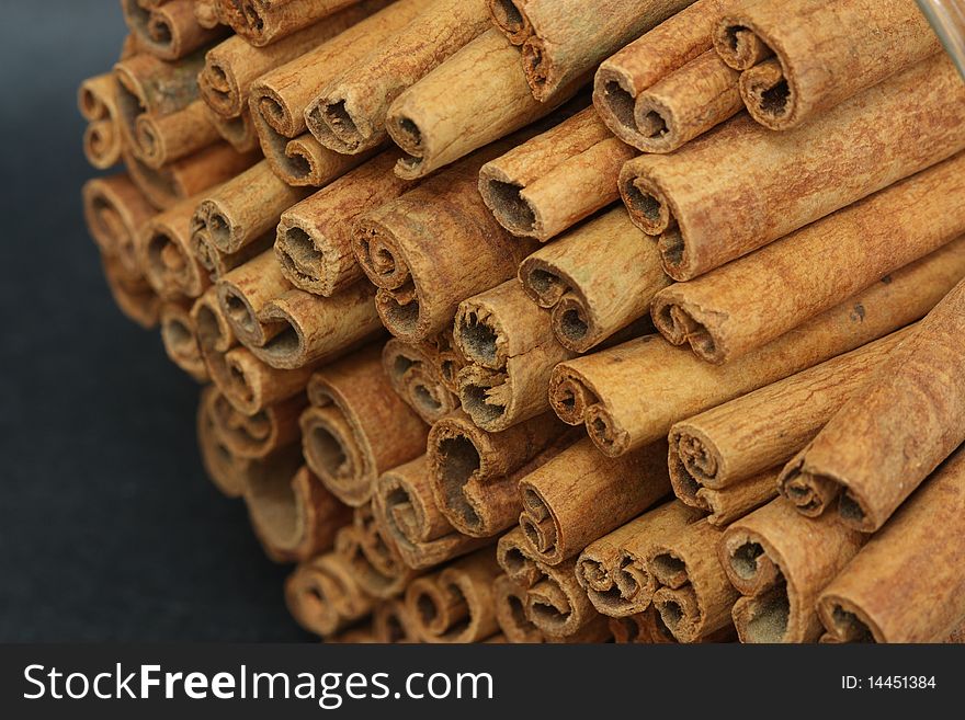 Stack of Cinnamon Sticks on a Black Background