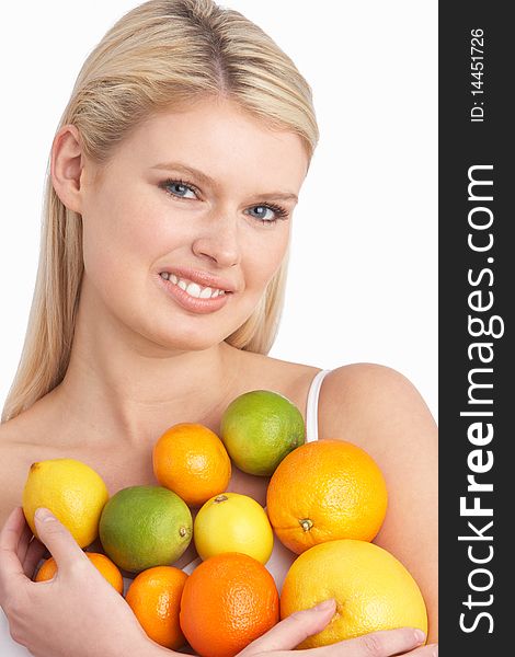 Young Woman Holding Citrus Fruit In Studio looking at camera