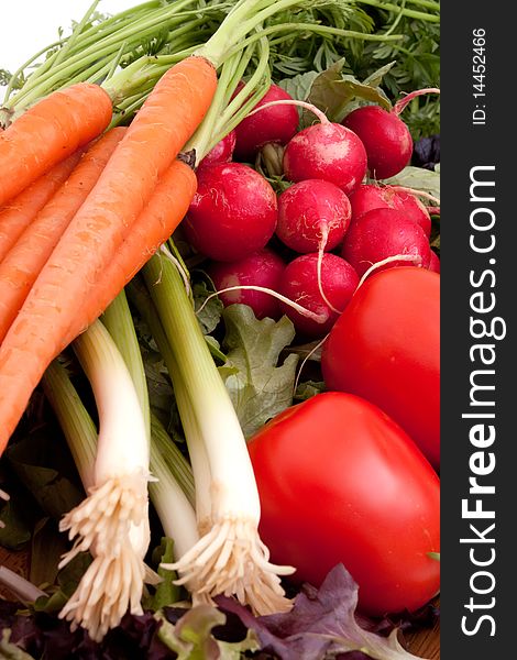 Fresh carrots, radishes, scallions, tomatoes and greens. Fresh carrots, radishes, scallions, tomatoes and greens