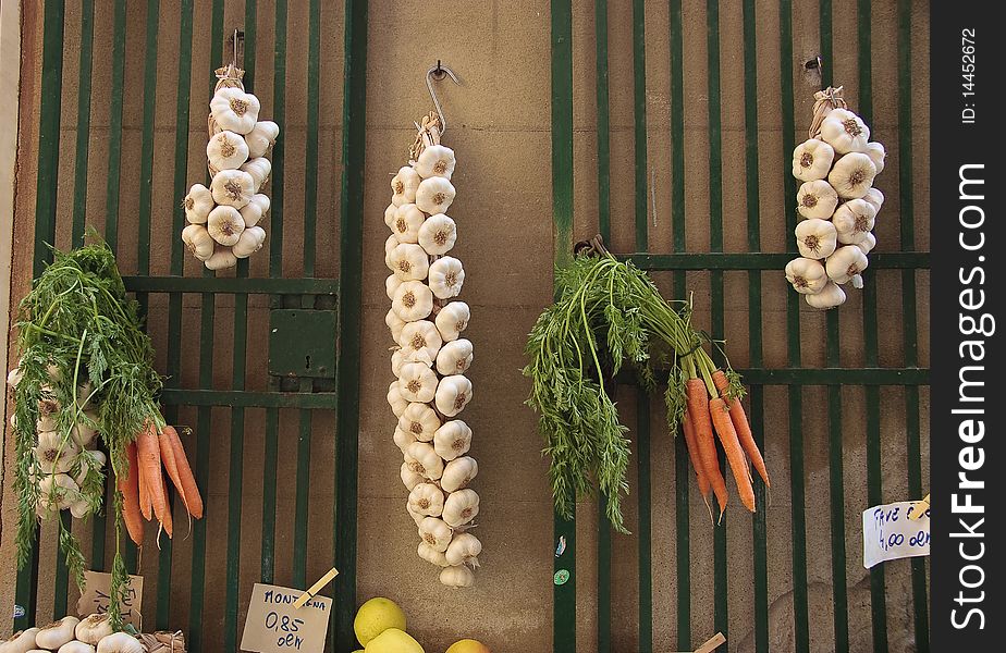 Garlic and carrots for sale on a local market in Italy. Garlic and carrots for sale on a local market in Italy