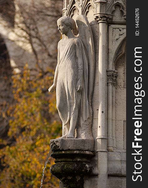 A statue and fountain in the garden behind Notre Dame Cathedral, Paris, France. A statue and fountain in the garden behind Notre Dame Cathedral, Paris, France