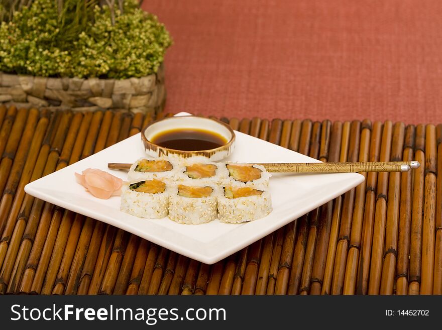 Plate of salmon rolls with soy sauce