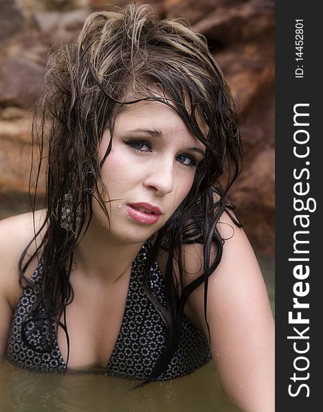 A beautiful woman in the water with wet hair.