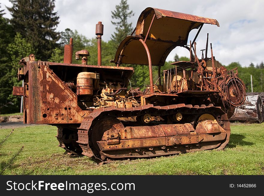 Old rusting bulldozer in logging yard
