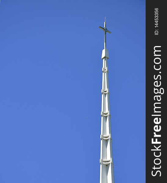 Church cross in the blue sky background