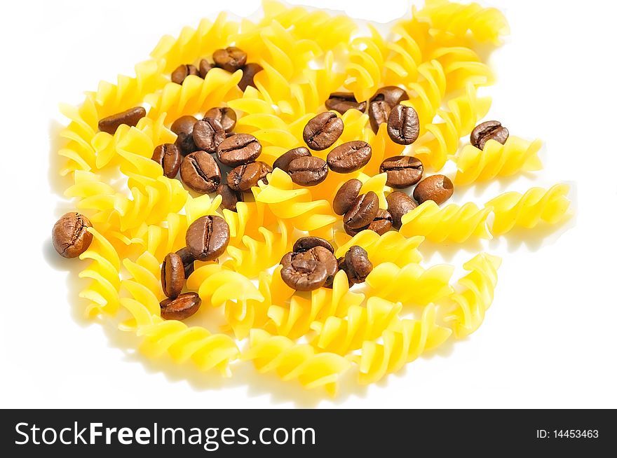 Photo coffee beans mixed with pasta on a white background. Photo coffee beans mixed with pasta on a white background