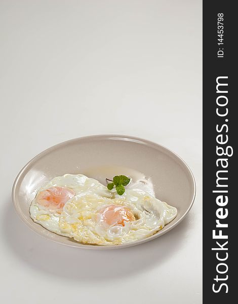 Tasty fried eggs with rice and tomato