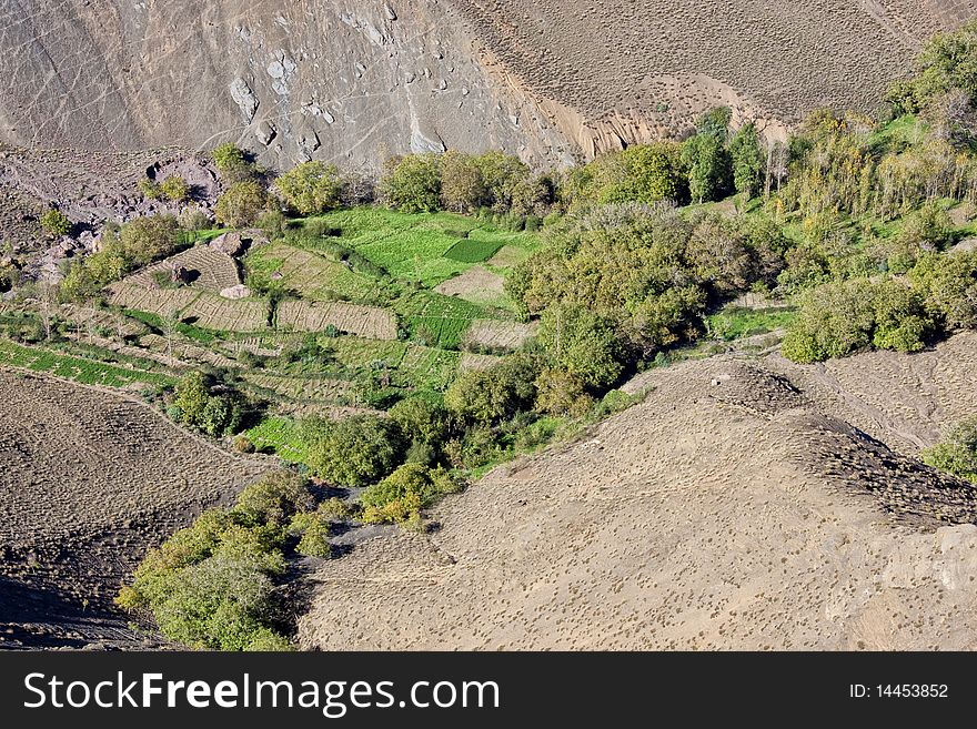 Agricultural fields in a valley surrounded by mountains. Agricultural fields in a valley surrounded by mountains