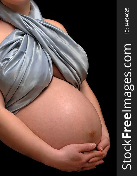 Pregnant woman belly isolated on black