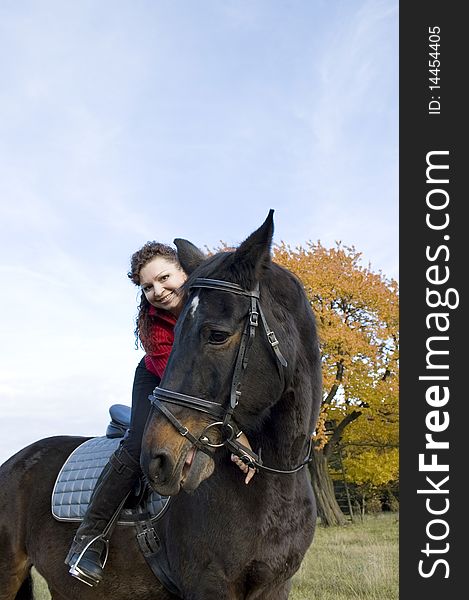 Housewoman bent down to the withers of the horse. Housewoman bent down to the withers of the horse.