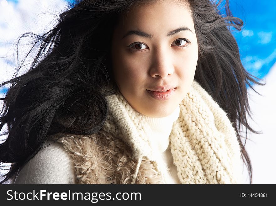 Young Woman Wearing Winter Clothes In Studio