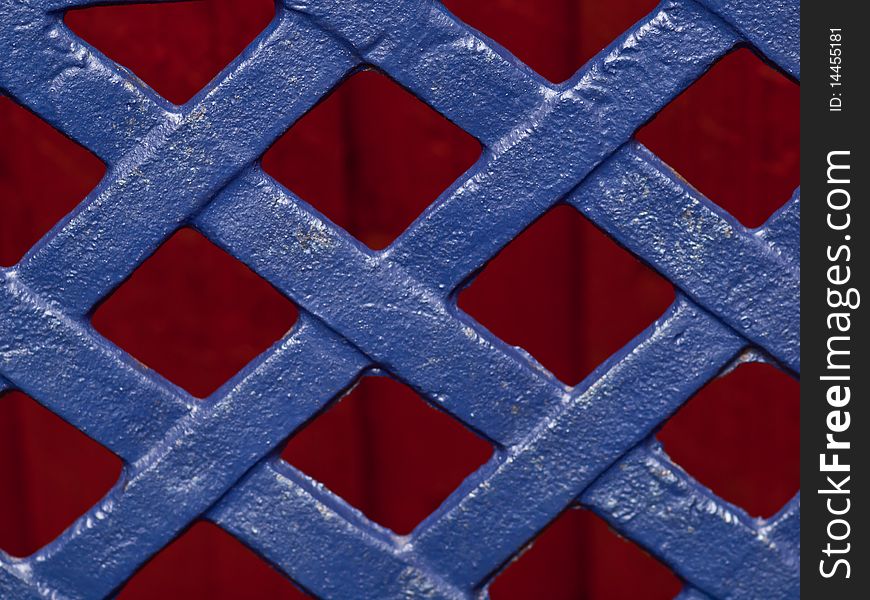 Blue pattern in cast iron on red wooden background. Blue pattern in cast iron on red wooden background.
