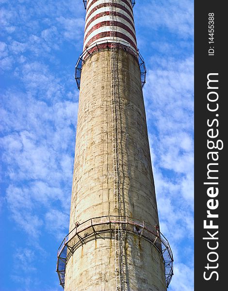 Industry chimney in a blue sky on sunny day