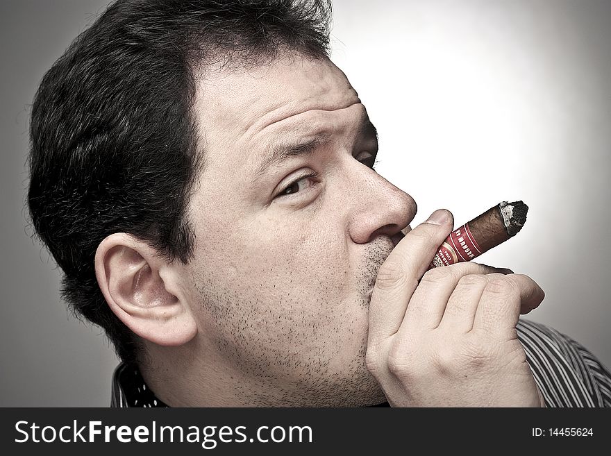 Handsome Man Smoking A Cigar.
